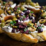 Herbed,olive,tapenade,with,goat,cheese,bruschetta:,appetizer,made,of