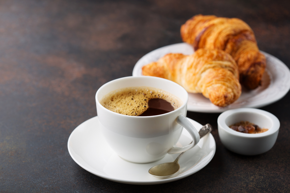 Coffee,white,cup,,croissants,on,dark,retro,background,,selective,focus.